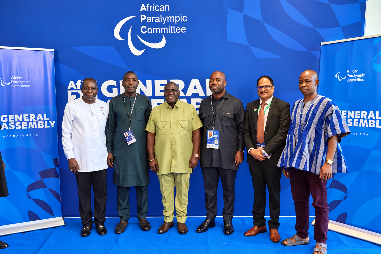 Six participants stand together for a group photograph at the Assembly.