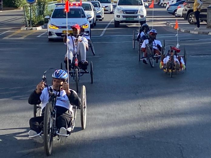 Windhoek handcyclists ride with a police escort.