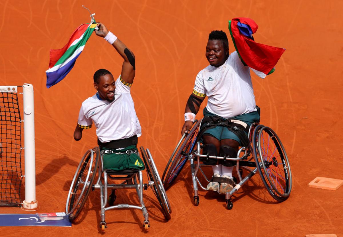 Ramphadi and Sithole wave South African flags