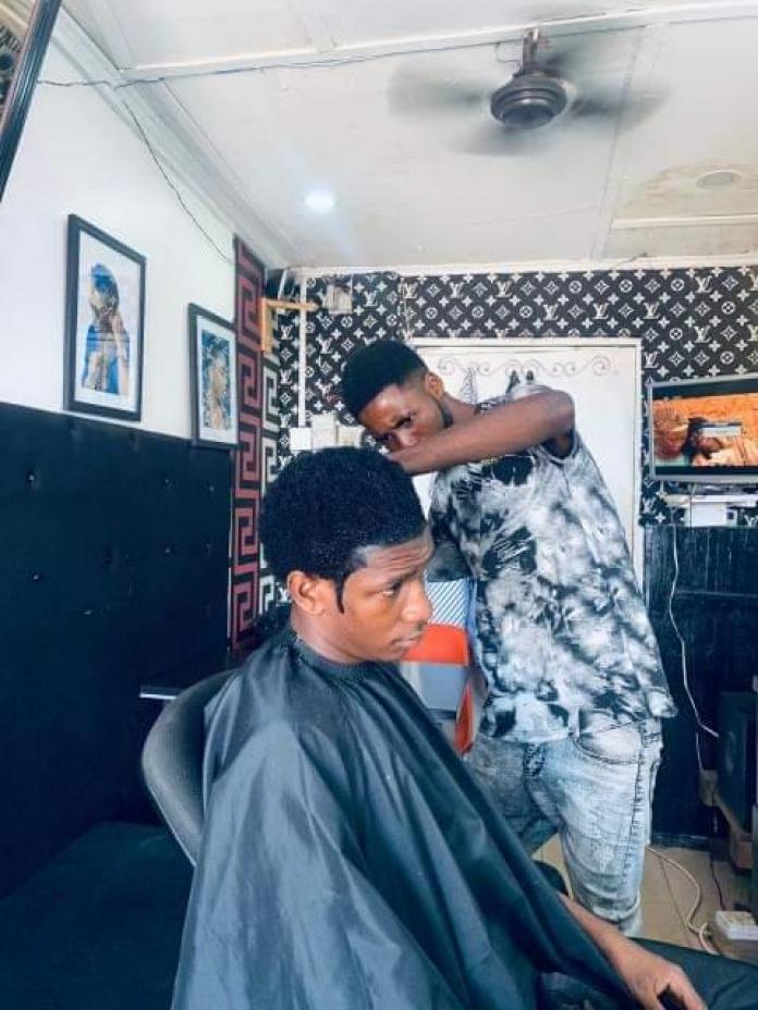Ahiagah combines athletics with work in a barbershop.