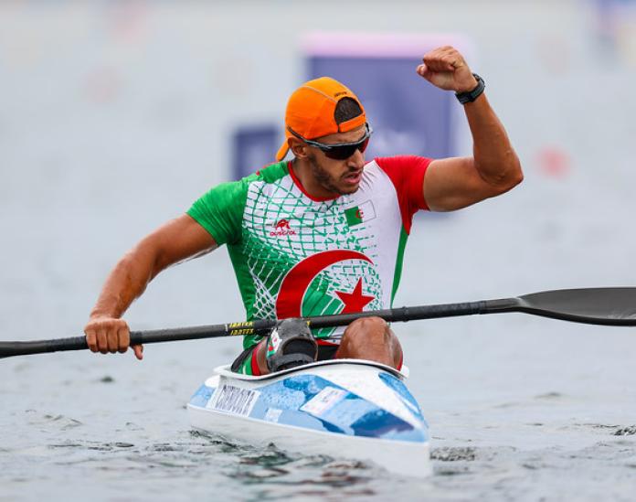 Guendouz raises a clenched fist.