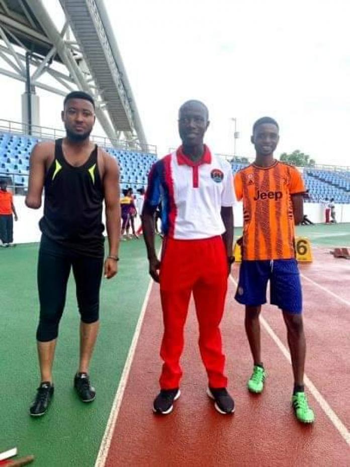 Ahiagah with another athlete and a coach on the track.