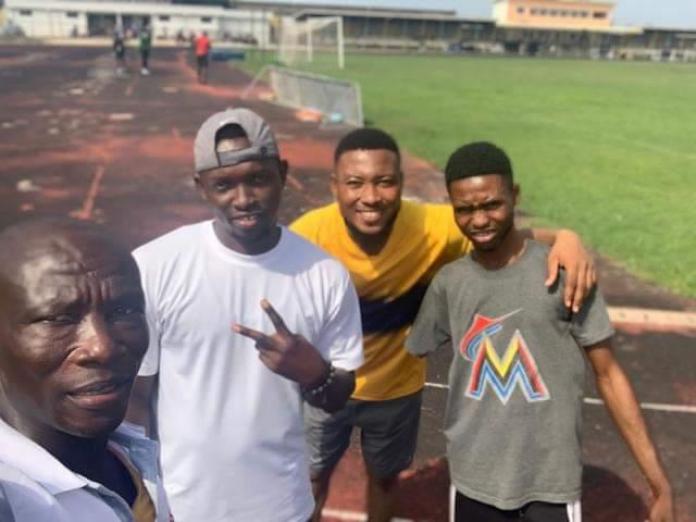 Ahiagah with fellow athletes and a coach.