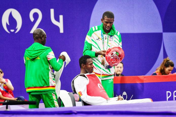 Keita sits with his coaching team