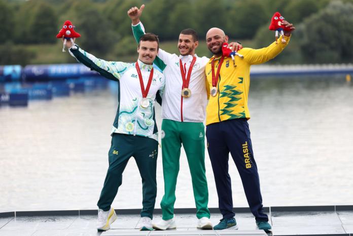 Three medal-winning athletes pose together.