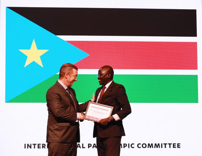 South Sudan's Kim Bany Joak receives the membership certificate
