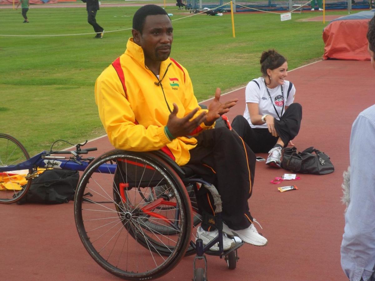 Botsyo Nkegbe seated beside an athletics track, as pictured in the IPC’s October 2020 feature on his Paralympic career.